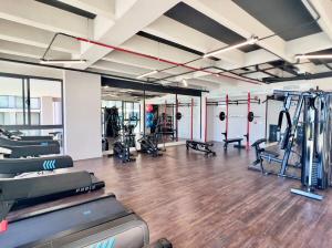 a gym with treadmills and machines in a room at Modern Beach Retreat Luxury Feel in Playa Bello Horizonte