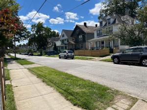 a street with cars parked in front of houses at Stay with Jay - Mapa Suite Cleveland in Cleveland