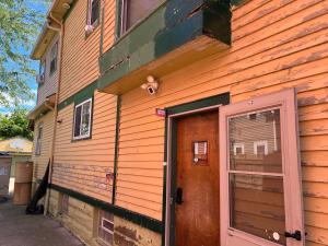 a wooden building with a door and a window at Stay with Jay - Mapa Suite Cleveland in Cleveland +7 photos