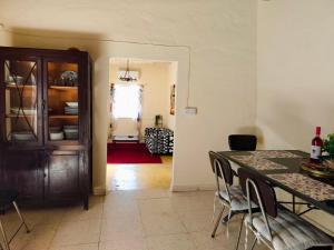 a dining room with a table and some chairs at DC Family Home & Garden - Traditional village house in Pano Arodes