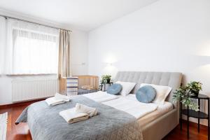 a bedroom with a large bed with blue pillows at Royal Retreat Luxury Apartment Lazienki Park in Warsaw
