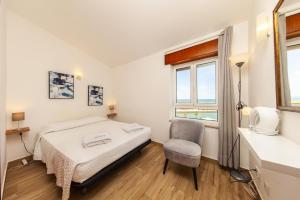 una camera da letto con un letto, una sedia e una finestra di Rising Sun Top-Floor Flat a Lagos
