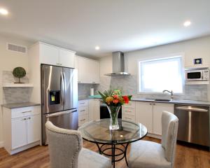 a kitchen with a table with a vase of flowers on it at The Loft Retreat in Southampton
