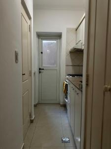a kitchen with a door and a tile floor at El lapacho 2 in Santiago del Estero +4 photos