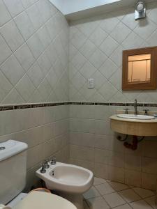 a bathroom with a toilet and a sink at El lapacho 2 in Santiago del Estero