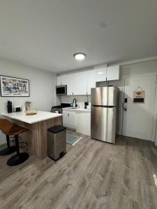 a kitchen with a stainless steel refrigerator and a table at Yale Casa Blanco in New Haven