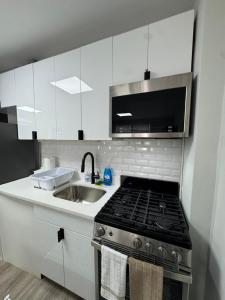 a kitchen with a stove top and a sink at Yale Casa Baya in New Haven
