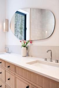 a bathroom with a sink and a mirror at Ghost Peak Chalet - Ski-In Access in Port Mann
