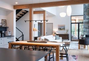 a kitchen and living room with a table and chairs at Ghost Peak Chalet - Ski-In Access in Port Mann +14 photos