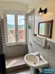 a bathroom with a sink and a window at Loggia Motovun in Motovun +12 photos