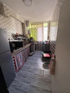 a kitchen with a counter and a room with a refrigerator at Comfortable apartment in Tangier