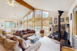 a living room with couches and a fireplace at Lucky Bear's Lair in Fairplay