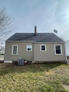 a brown house with a roof and a yard at Duncan Enterprise Homes in Akron