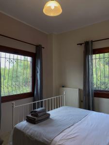 a bedroom with a bed with towels on it at Casa StefanoS in Afitos +65 photos
