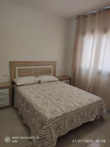 a bedroom with a large bed with a wooden headboard at Villa Mirador de la Loma in Pájara