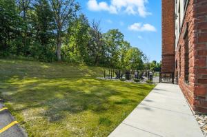 a walkway leading to a yard with a gate at Cobblestone Hotel & Suites - Bellefontaine in Bellefontaine
