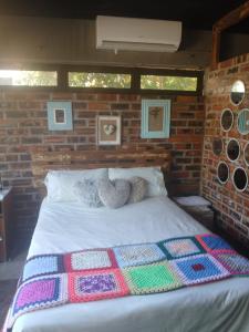 a bed with two stuffed animals on top of it at Urban Villa 83 in Gaborone