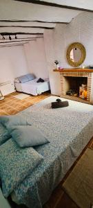 a bedroom with a large bed and a mirror at Casa Ariadna in Bocairent