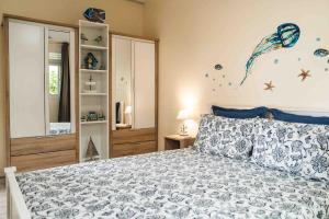 a bedroom with a bed with a kite on the wall at Matira Blue House in Bora Bora