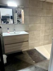 a bathroom with a sink and a mirror at Pleasant townhouse with free parking in Saint-Cyprien