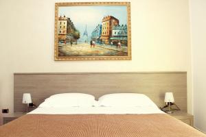 a bedroom with a bed with a painting above it at Suitedelmare in Gallipoli +95 photos