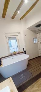 a white bath tub in a room with a window at Casa Ariadna in Bocairent +35 photos