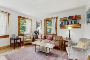 a living room with a couch and chairs and a table at Turner Hill Cottage in West Townshend