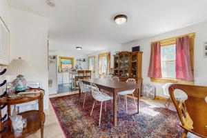 a kitchen and dining room with a table and chairs at Turner Hill Cottage in West Townshend