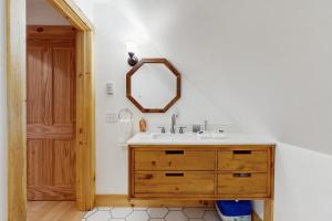 a bathroom with a sink and a mirror on the wall at Turner Hill Cottage in West Townshend +17 photos