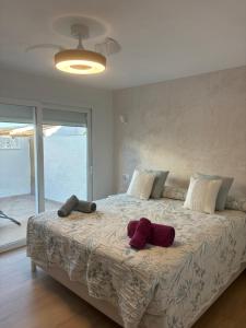 a bedroom with a large bed with red pillows on it at La Perla del Mar in Estepona +42 photos