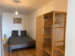 a bedroom with a bed and a book shelf at Superbe terrasse avec vue panoramique sur la mer in Marseille