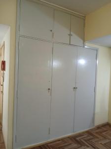 a large closet with white cabinets in a room at carmon colon 1 ambiente y medio in Mar del Plata