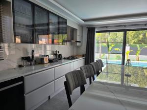 a kitchen with a table and some chairs and a window at Dalyan Villa Oliva in Dalyan