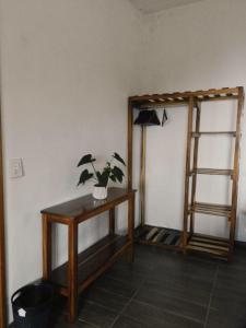 a room with a table with a plant on it at Casita Ikal in Cedro +10 photos