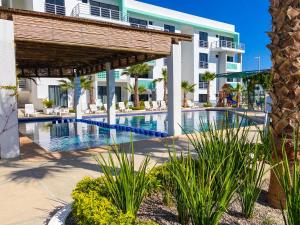 a view of a swimming pool at a resort at Índigo 7, Steps from Playa Brujas Beach in Mazatlán