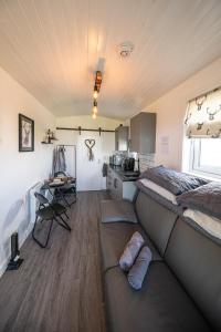 a room with a bed and a kitchen in it at Farr North Lodge 1 By The Sea in Wick