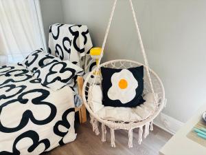 a swing with a pillow in a room at Chic & Cozy Studio Retreat in Memphis