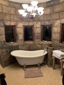 a bath tub in a bathroom with a stone wall at View Nauvoo and the Mighty Mississippi Sidon in Nauvoo