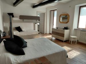 a bedroom with two bunk beds and a mirror at Da Ciro e Angela in Barolo