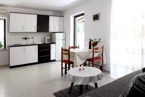 a living room with a table and a kitchen at Apartments Marina-Mare in Poreč