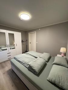 a bedroom with a large bed with a lamp on it at Lofoten-City Center-New apartment-Near the airport in Leknes +40 photos