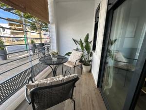 a balcony with a table and chairs and a table at Apartamentos Matilda Conil - Playa in Conil de la Frontera