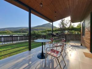 a table and chairs on a patio with a view at Oda in Mtskheta in Mtskheta