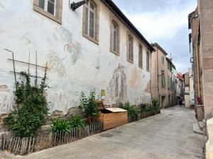 a building with a mural on the side of it at UrbanSoul Millau in Millau