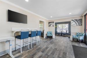 a bar in a waiting room with chairs and a flat screen tv at Best Western Courtesy Hotel - Anaheim Resort Amusement Park in Anaheim +37 photos