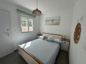 a bedroom with a bed and a window at Beach House Renata in Gran Alacant +27 photos