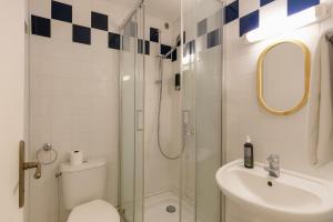 a bathroom with a shower and a toilet and a sink at Résidence Chlorophylle - Arcueil in Arcueil