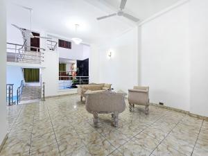a living room with chairs and a ceiling fan at Evolve - Royal Mount in Mount Lavinia