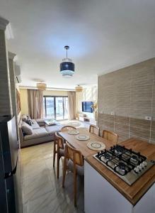 a kitchen and living room with a table and a stove at B15/87/51 · Madinaty B15 Brand new 3BR Apt in Madinaty