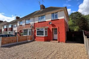a red brick house on a gravel driveway at 3 Bedroom Property, Free Parking for 3 Vehicles in Mile End